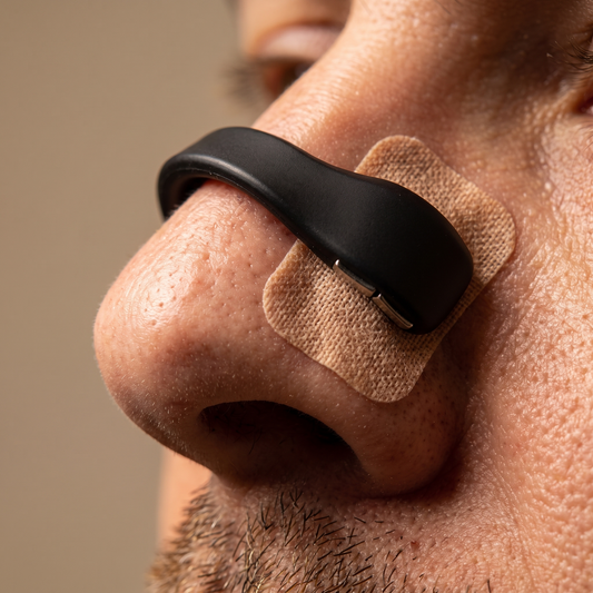 Macro close-up of the Tezz AirGrip magnetic bridge worn on the nose with an adhesive pad on the side